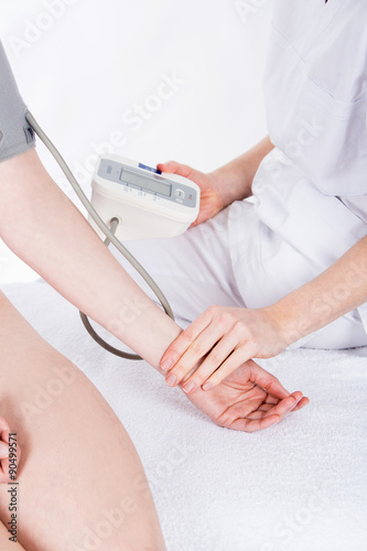 doctor measure the blood pressure to woman patient