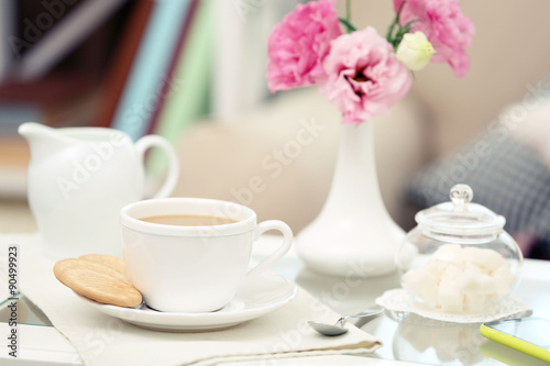 Cup of coffee on table in living room