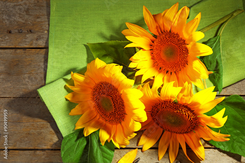 Fototapeta Naklejka Na Ścianę i Meble -  Beautiful bright sunflowers on wooden table close up