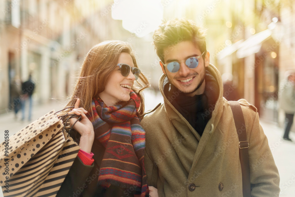 stylish young couple doing shopping in the street