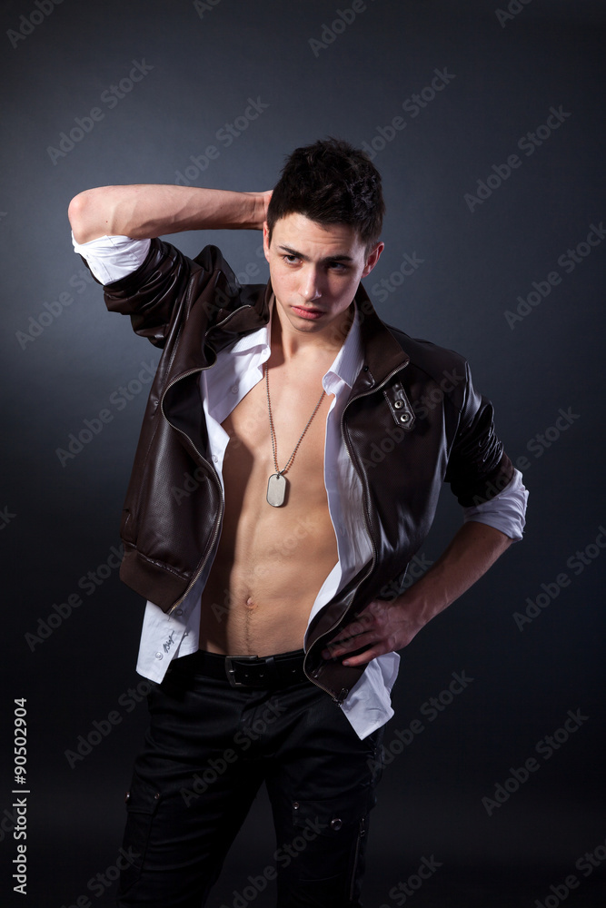 Healthy muscular young man on grey background