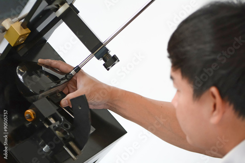 Club Maker checking the loft angle of golf club