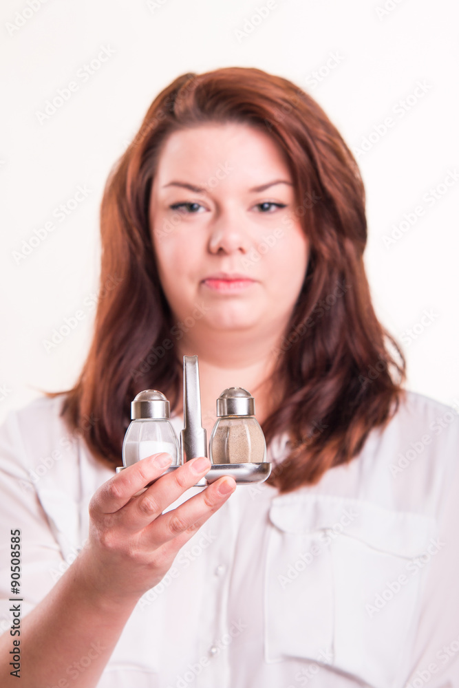 Salt and pepper cellar in hand of woman