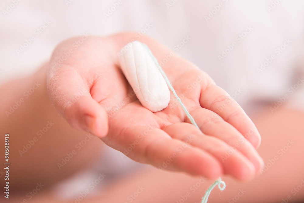 Tampo on womans hand before intravaginal aplication Tampo on womans hand before intravaginal aplication