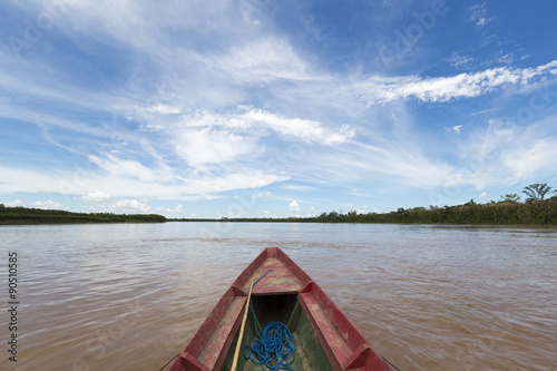 Journey on a wooden boat on Beni river near Rurrenabaque, blue s