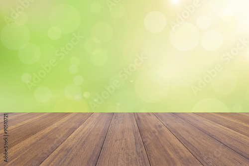 Abstract bright spring with sunlight bokeh background from tree and wooden plank