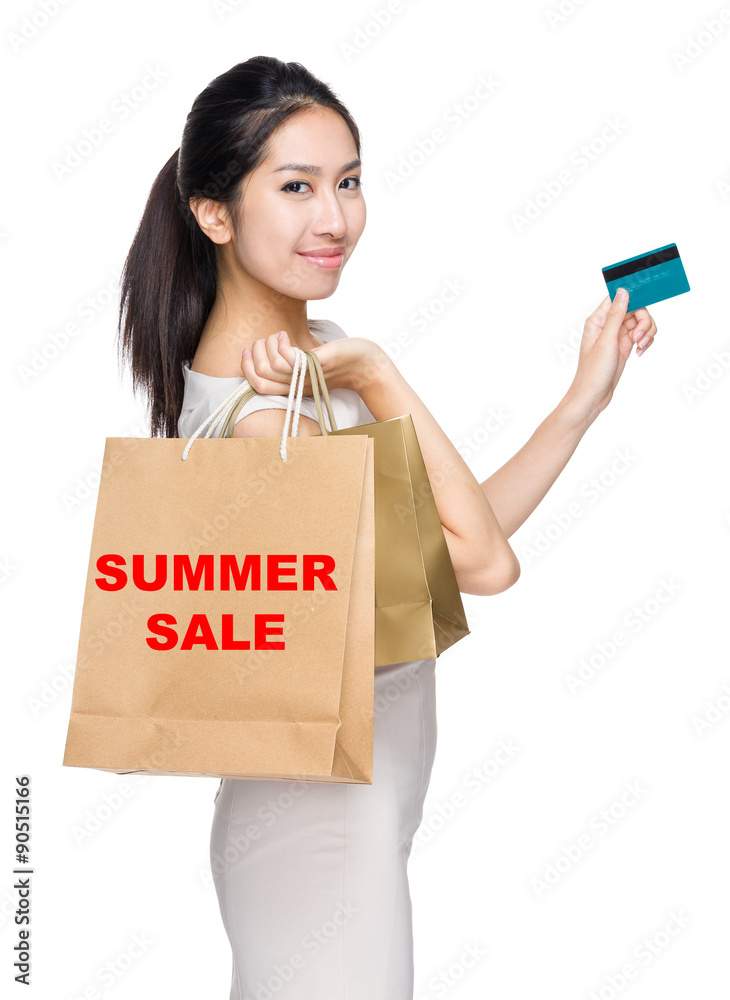 Woman with credit card and holding shopping bag for showing summ Woman with credit card and holding shopping bag for showing summ
