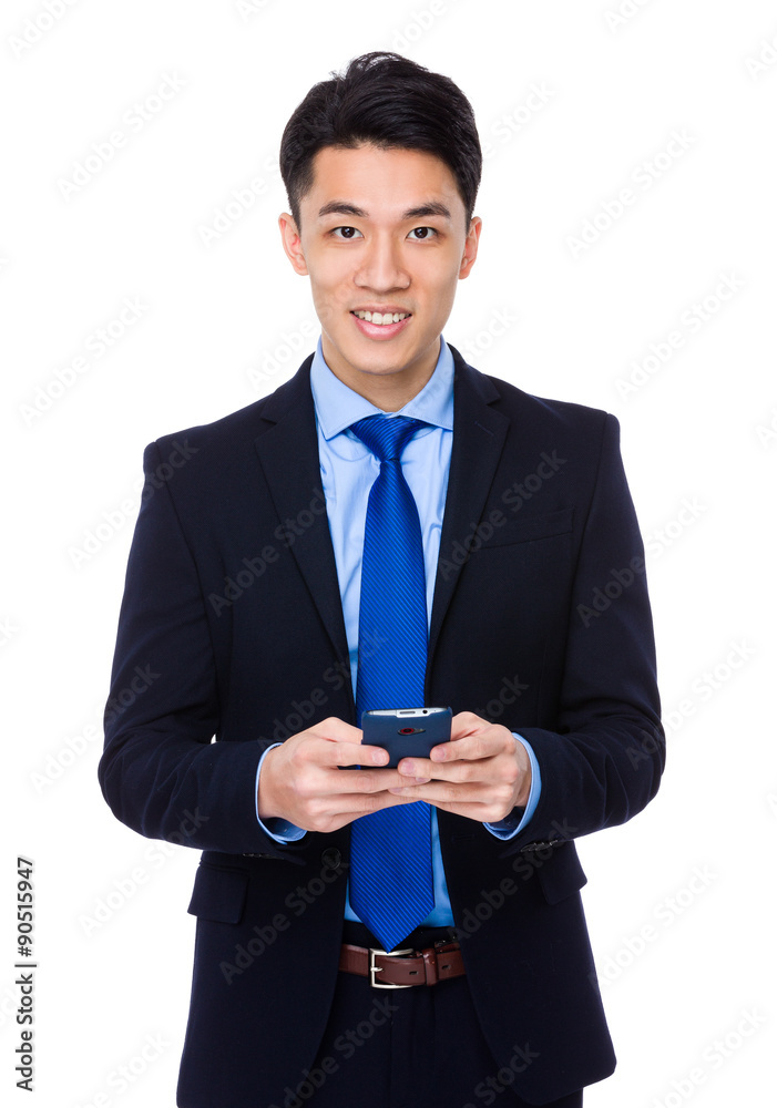 Asian young businessman use of the mobile phone Asian young businessman use of the mobile phone
