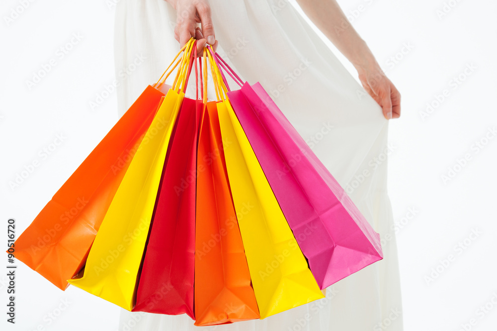 Happy young woman with multicolored shopping bags