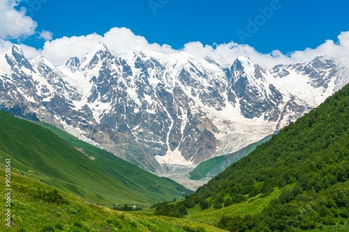 Beautiful grassy valley and snow-capped mountains in Georgia