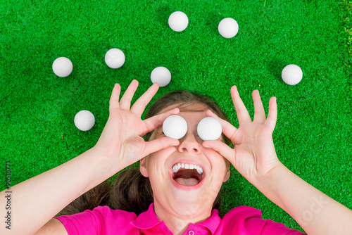 Funny portrait of a girl with golf balls