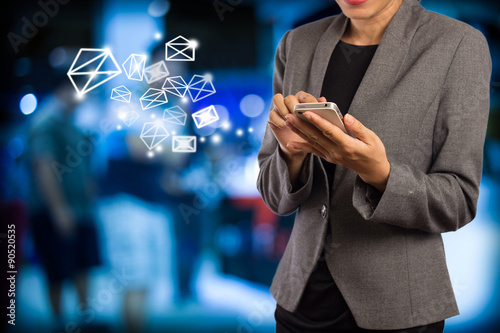 Business woman sending ema byi using mobile phone. photo