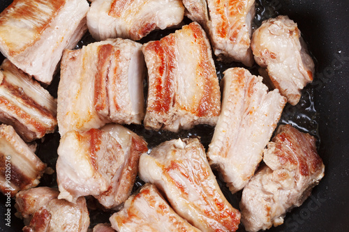Roasted pork ribs on a blac...