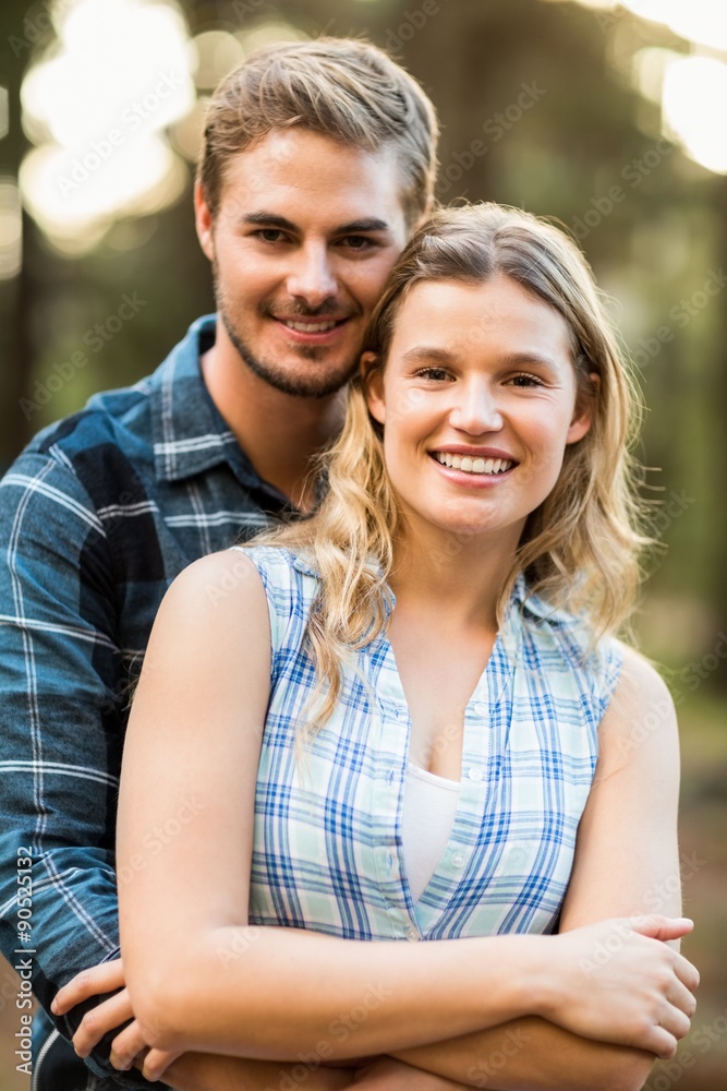 Happy smiling couple embracing and looking at the camera Happy smiling couple embracing and looking at the camera