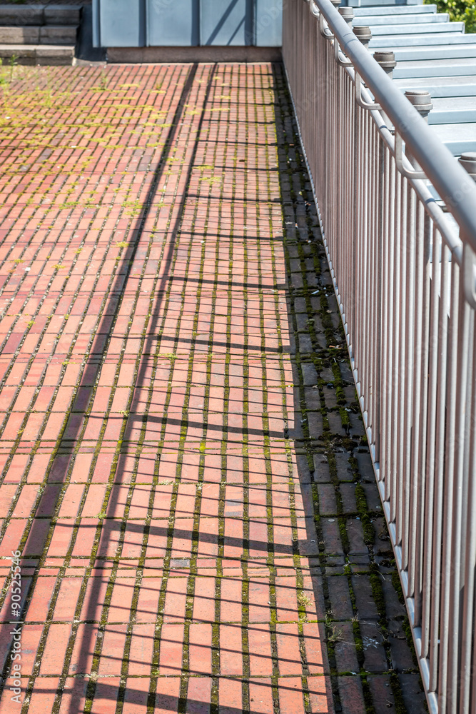 Railings, shadows and brick floor Railings, shadows and brick floor