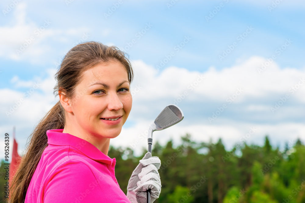 girl in a bright pink T-shirt with a golf club girl in a bright pink T-shirt with a golf club