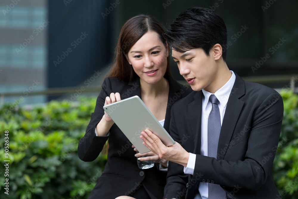 Business people discuss about the project display on digital tab Business people discuss about the project display on digital tab