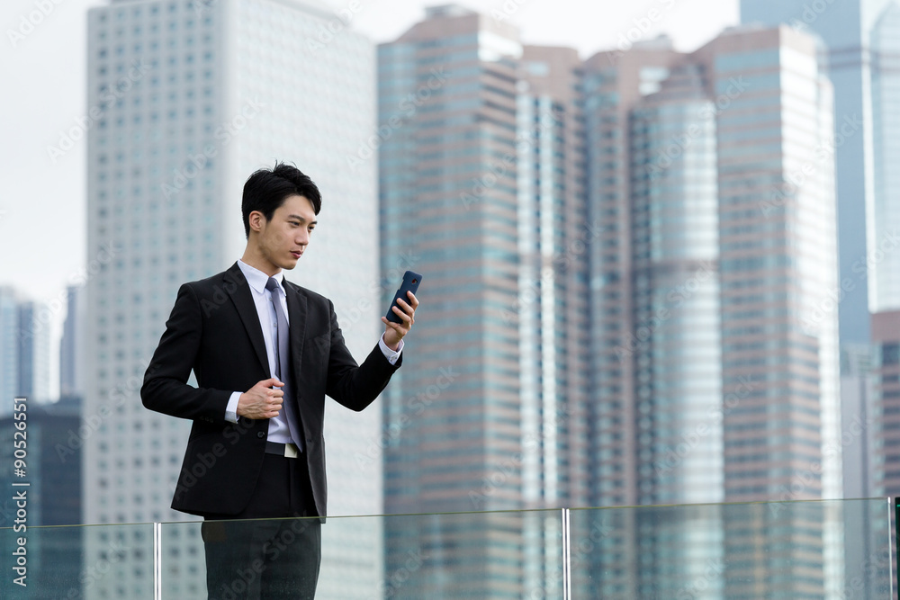Businessman read the message on cellphone Businessman read the message on cellphone