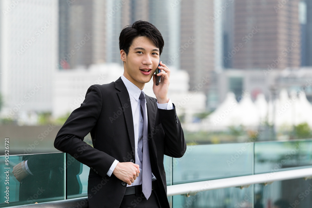 Businessman discuss about something though cellphone Businessman discuss about something though cellphone