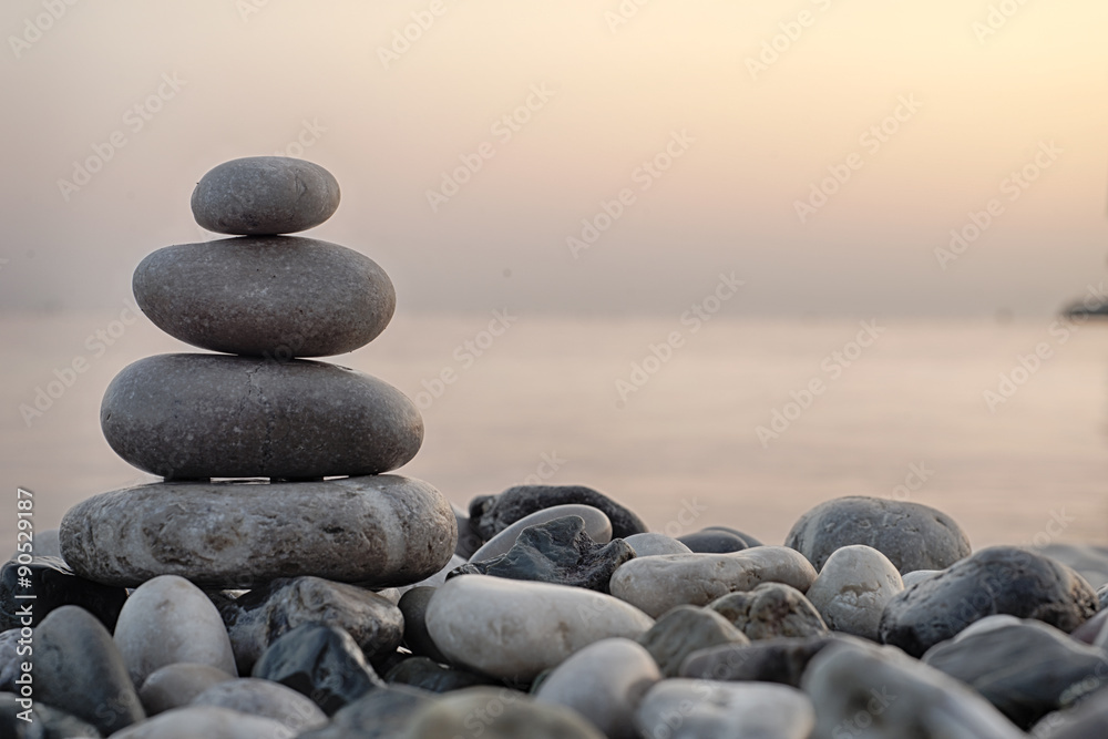 Stack of round smooth stones on a seashore