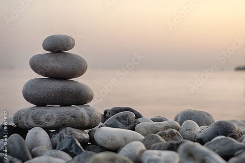 Stack of round smooth stones on a seashore photo