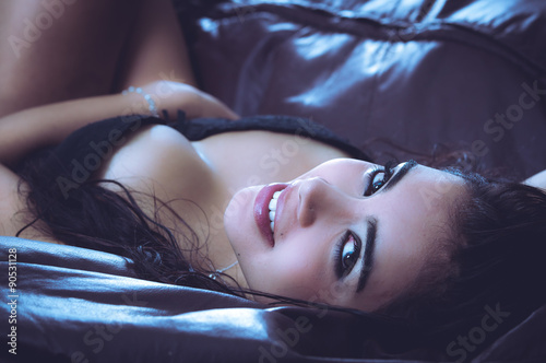 Fotografie Sexy latina model lying in seductive position revealing some