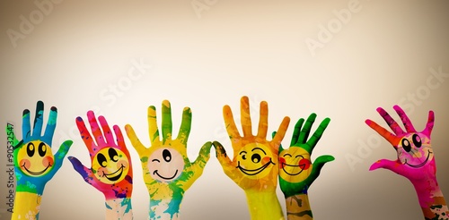 Composite image of hands with colourful smiley faces