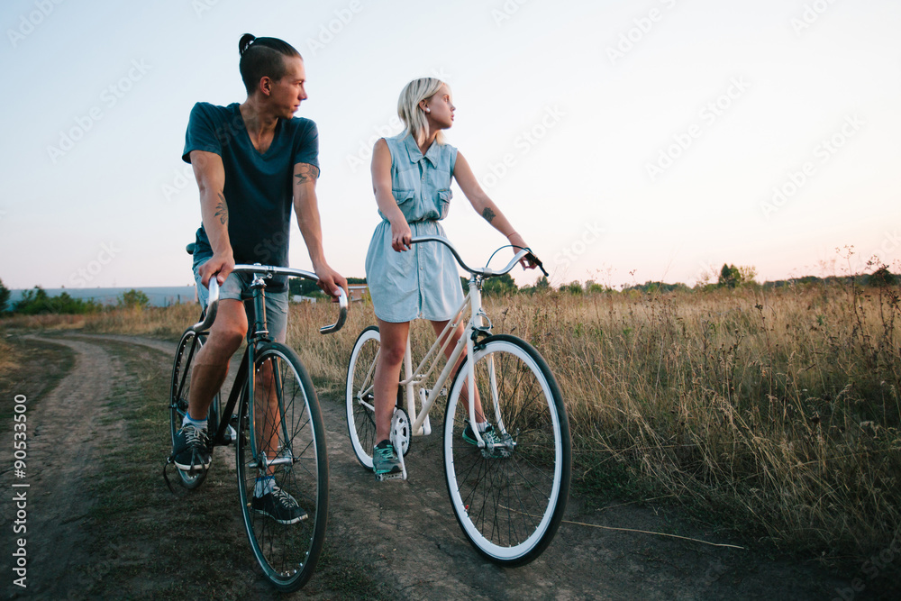 young couple on vintage bikes riding