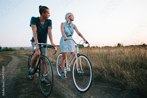 Fototapeta Naklejka Na Ścianę i Meble -  young couple on vintage bikes riding