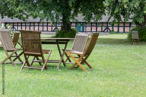 table and chairs / Table and chairs on the lawn in front of the barn 