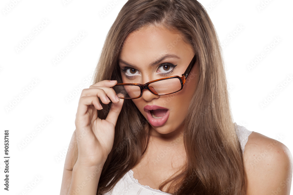 surprised beautiful girl with glasses posing on white