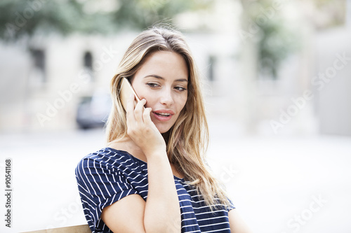 Young pretty woman talking on mobile phone