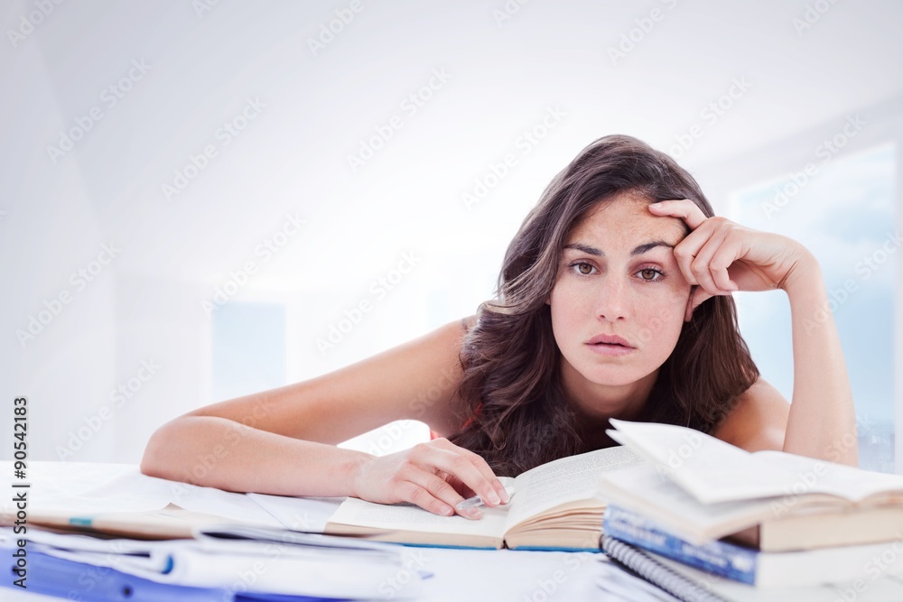 Composite image of bored student doing her homework Composite image of bored student doing her homework