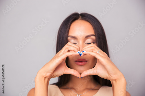 Принти на полотні Attractive woman making heart with fingers