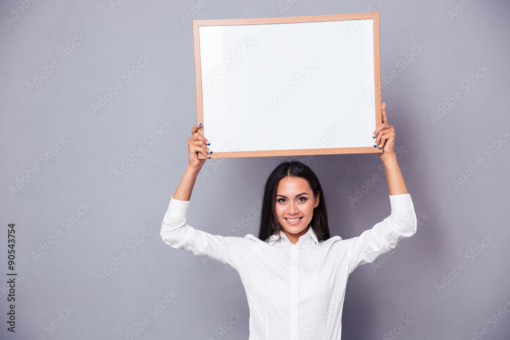 Portrait of a happy woman holding blank board on head Portrait of a happy woman holding blank board on head