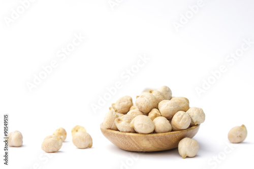 Chick peas on wooden spoon isolated on white background