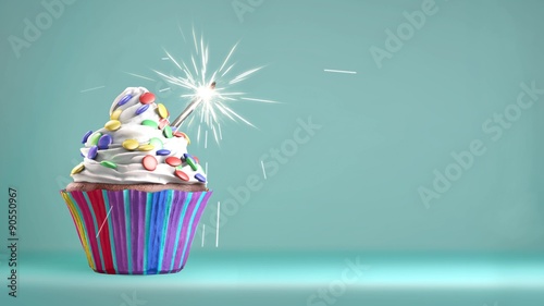 Delicious cupcake with a glittering sparkler and smarties on a whipped cream. Copy space available. 4k video.
