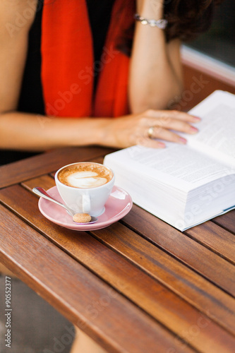 An open book and a coffee cup