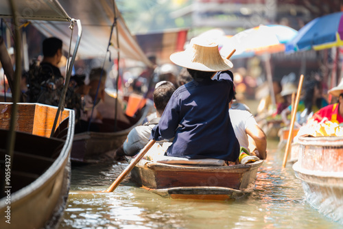 Woman paddle rowboat  in floating market © Sichanista