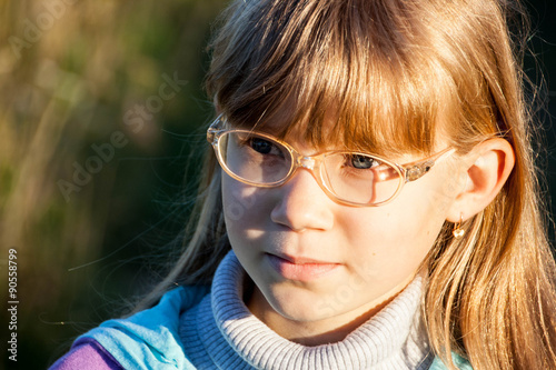 Smiling little blond girl with glasses © alexx_60