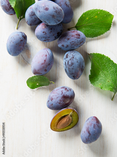 fresh plums on old wooden t...