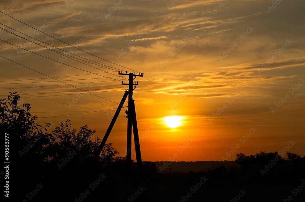 electric pole on the background of sunset