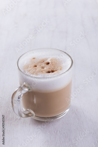 Coffee cup on grunge white wooden background