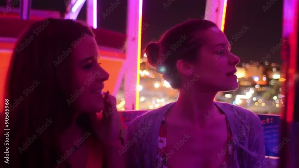 Two friends on a ferris wheel at night
Two friends on a ferris wheel at night