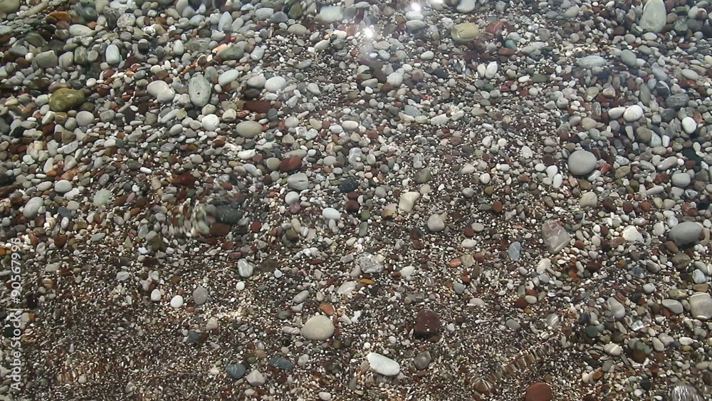 Background of Transparent waves of the sea run over on the beautiful pebble beach Background of Transparent waves of the sea run over on the beautiful pebble beach