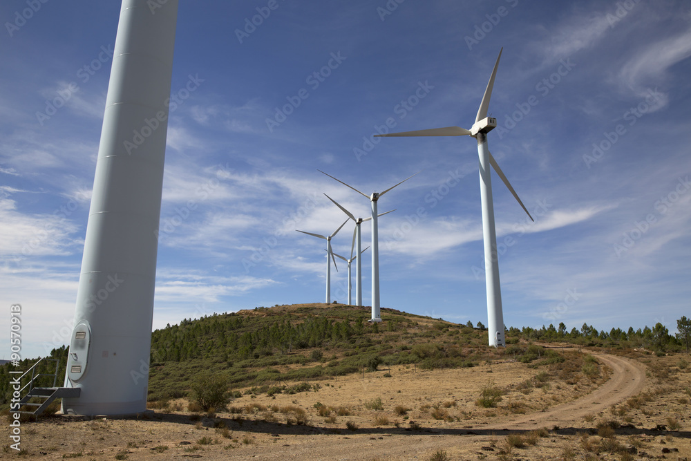 Eolic wind Turbines on a modern windmill farm for alternative energy generation