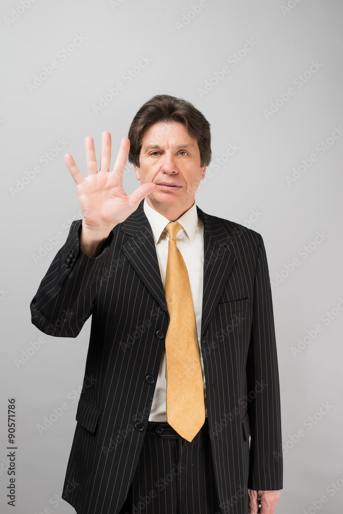Happy businessman showing five fingers on a gray background Happy businessman showing five fingers on a gray background