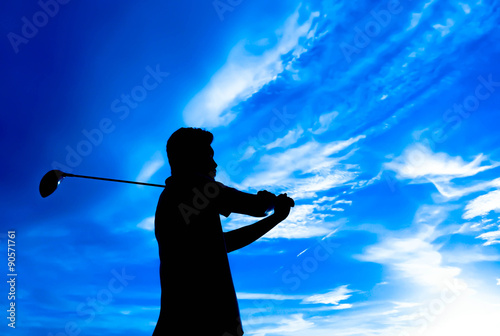 Golfer silhouette swinging at sunset design background