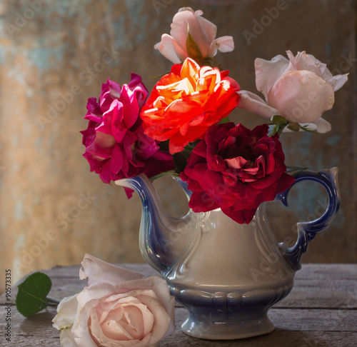 stiill life with roses on grunge background photo