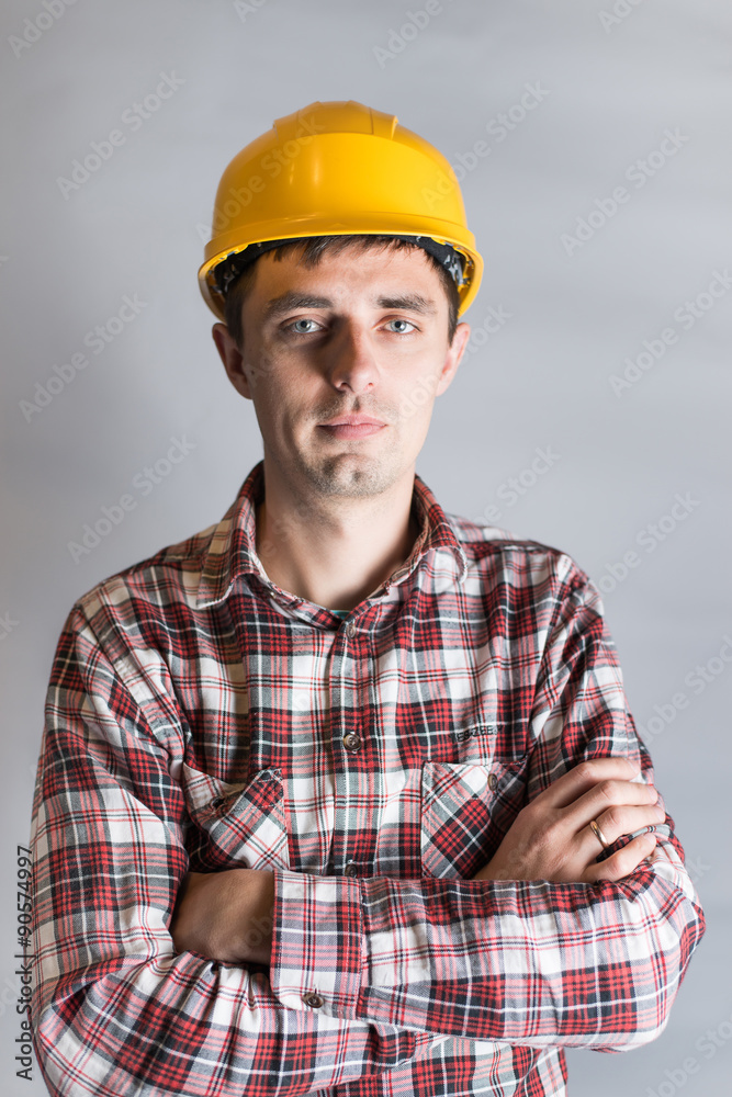 young man in a construction helmet, builder young man in a construction helmet, builder